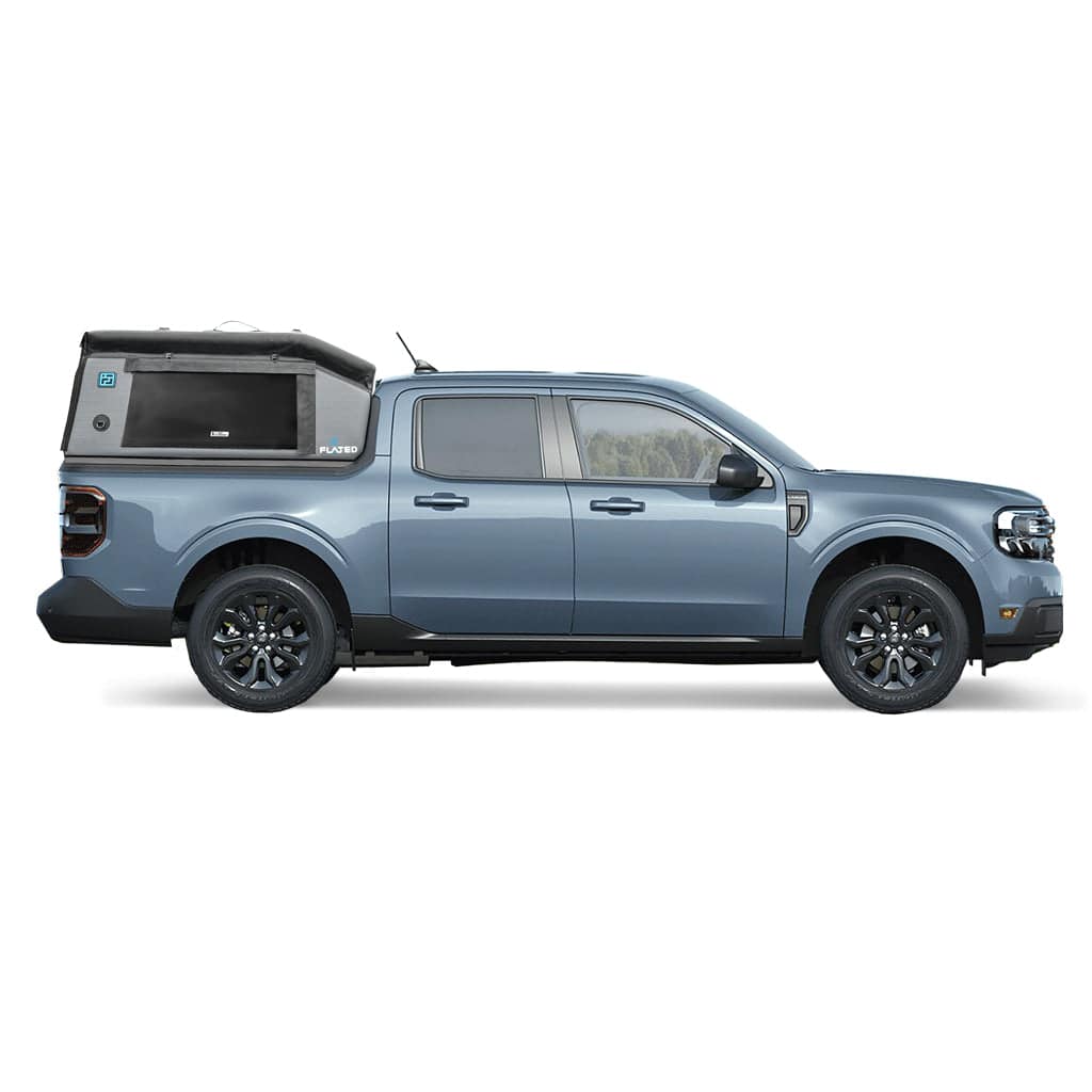 A grey pickup with a raised, inflatable FLATED COMPACT-MAVERICK MR46 truck shell on the bed, featuring a large side window and logo. This camper shell adds height and storage, making it a versatile topper.