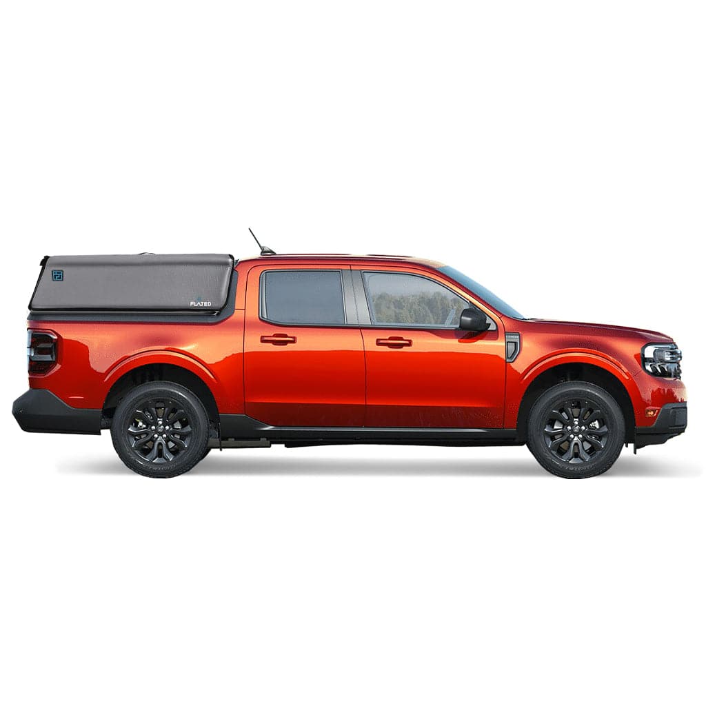 A gray pickup with a black FLATED COMPACT-MAVERICK CAP46 inflatable truck topper, partially covering the bed. The topper displays the FLATED brand name and a small blue logo on the side.