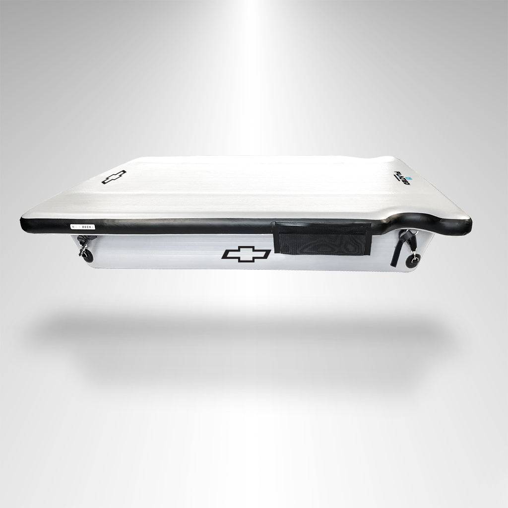 The FLATED FULL-STANDARD DECK66 SILVERADO, a white and black GM-licensed Chevrolet Silverado Air-Deck truck bed cover, is displayed floating on a light gray background with a subtle spotlight effect.