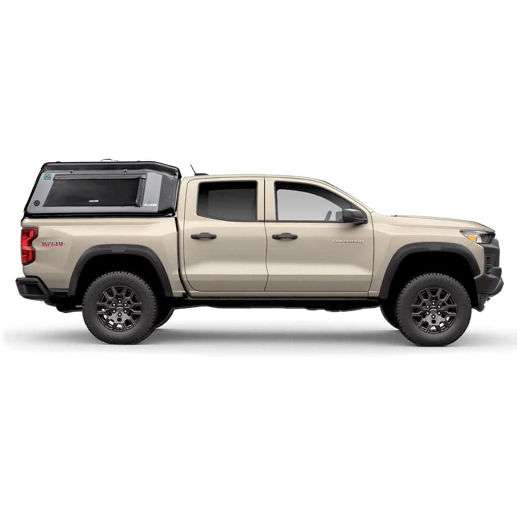 A white pickup truck in profile on a white background with a FLATED MID-SHORT MR50 gray and black Tacoma bed topper, featuring a large side window and FLATED branding on the side.
