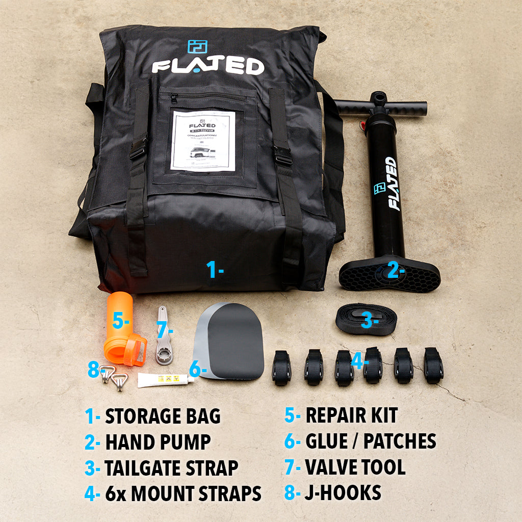 A FLATED FULL-SHORT CAP54 (OPEN BOX) topper storage bag and contents—hand pump, tailgate strap, six mount straps, repair kit with glue/patches, valve tool, and eight J-hooks—are displayed and labeled on a concrete surface.