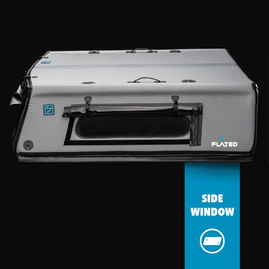 The FLATED FULL-STANDARD DT CAP64, a gray rectangular inflatable truck cap, features a black side window, black handles, and FLATED branding. A blue "SIDE WINDOW" label with icon appears. Perfect for full-size truck bed coverage.
