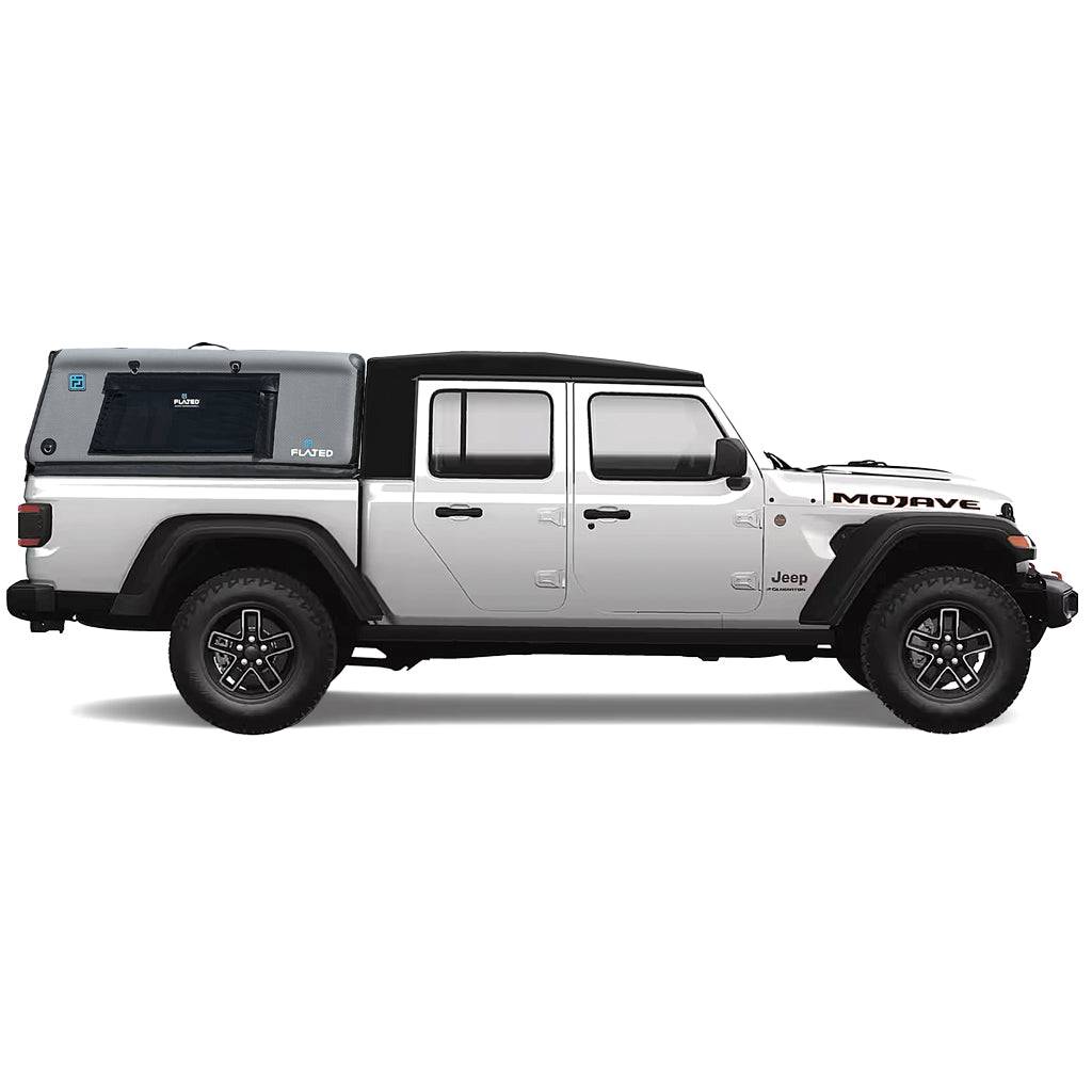 A gray pickup truck is equipped with a FLATED MID-SHORT CAP51 black and gray Air-Topper inflatable truck shell, securely installed over the bed with a side window for convenient coverage during outdoor adventures.