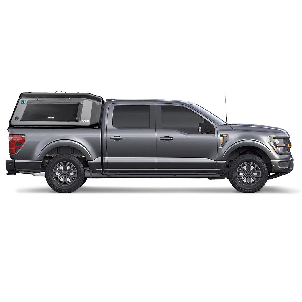 A silver pickup with a gray and black FLATED FULL-SHORT MR54 inflatable truck shell on the bed, featuring a zippered window and the FLATED brand name on the side.