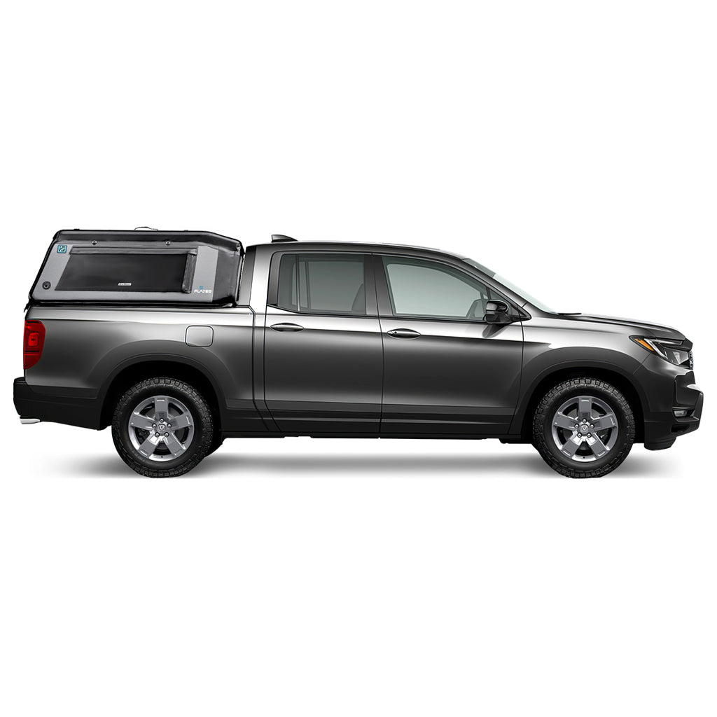 A white pickup truck with a FLATED MID-SHORT HR MR53 gray and black insulated topper attached to the bed, featuring a side window and rugged outdoor-ready design.