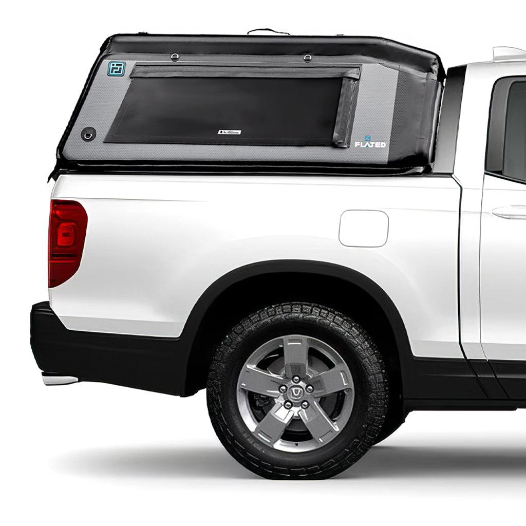 A white pickup truck with a FLATED MID-SHORT HR MR53 gray and black insulated topper attached to the bed, featuring a side window and rugged outdoor-ready design.