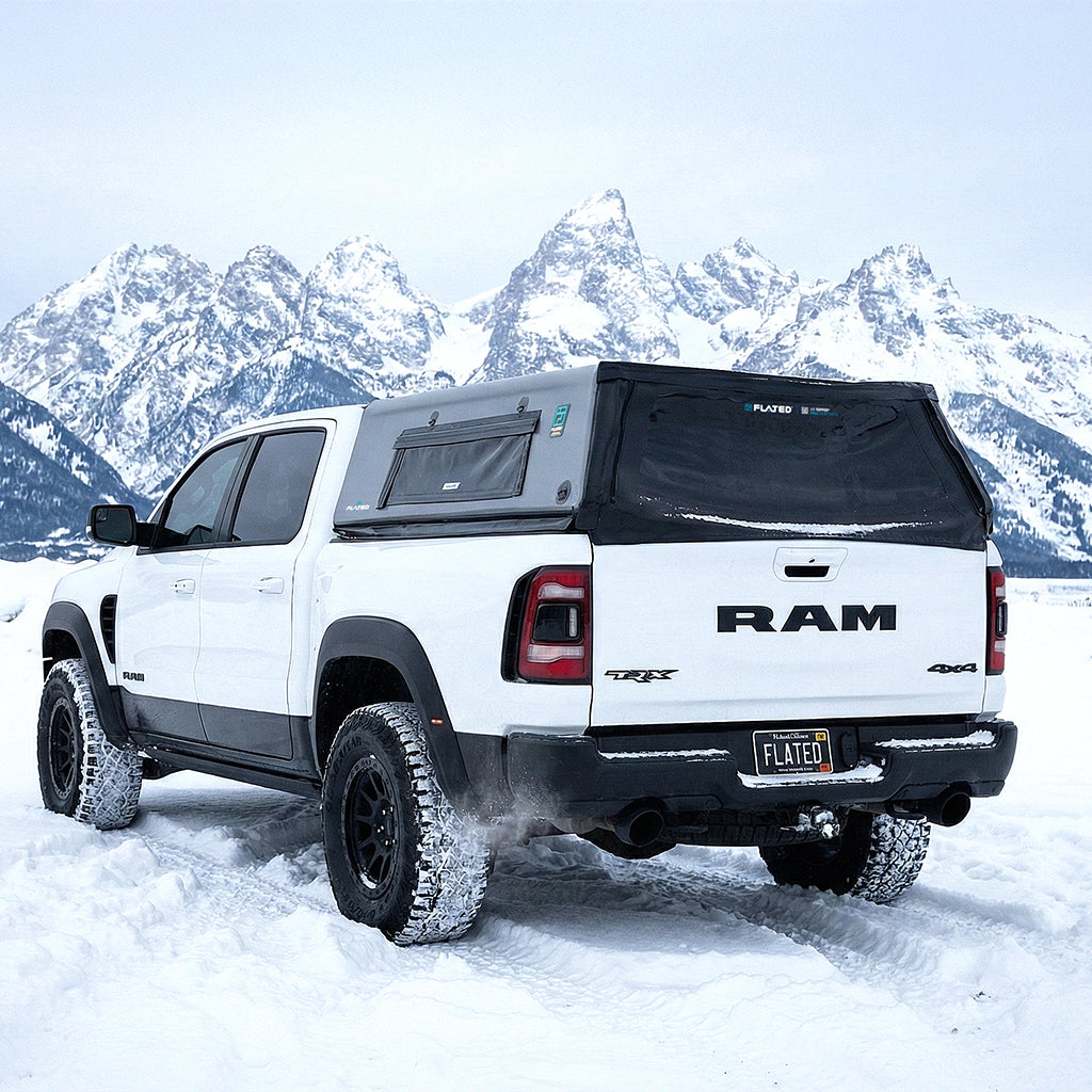 White Ram truck with a black tonneau cover in a snowy mountain landscape. (Mopar Affiliate)
