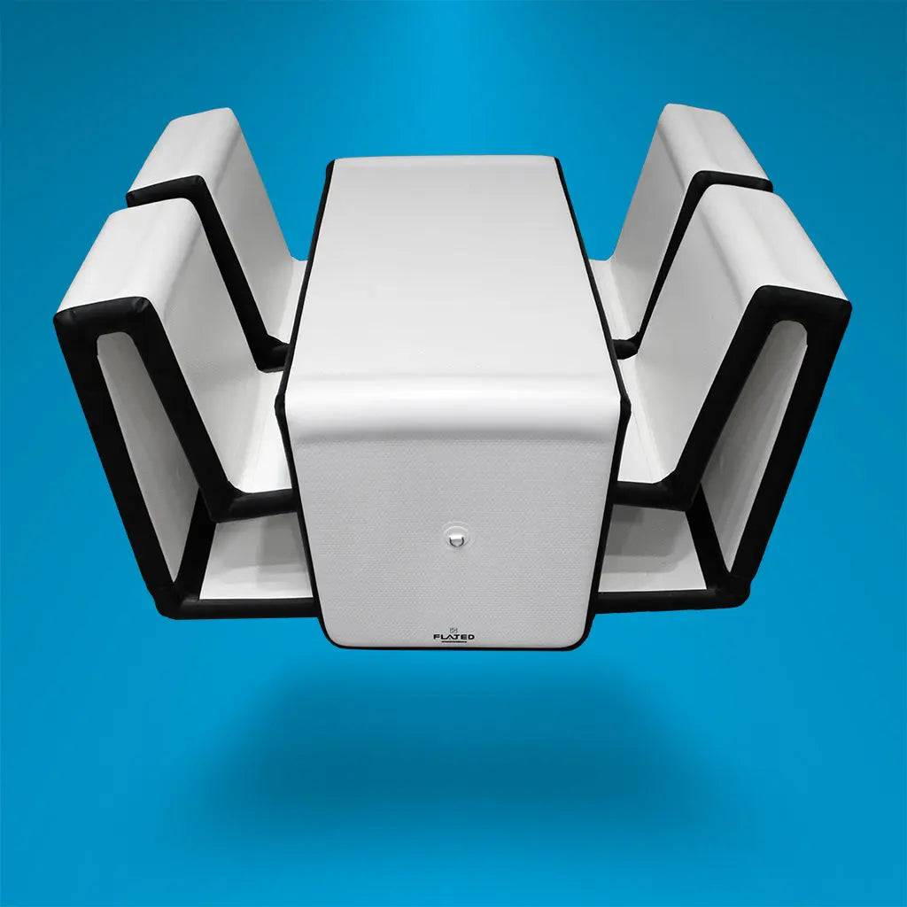 A modern dining set with four white chairs with black edges, neatly integrated around a matching rectangular table, all floating against a bright blue background.