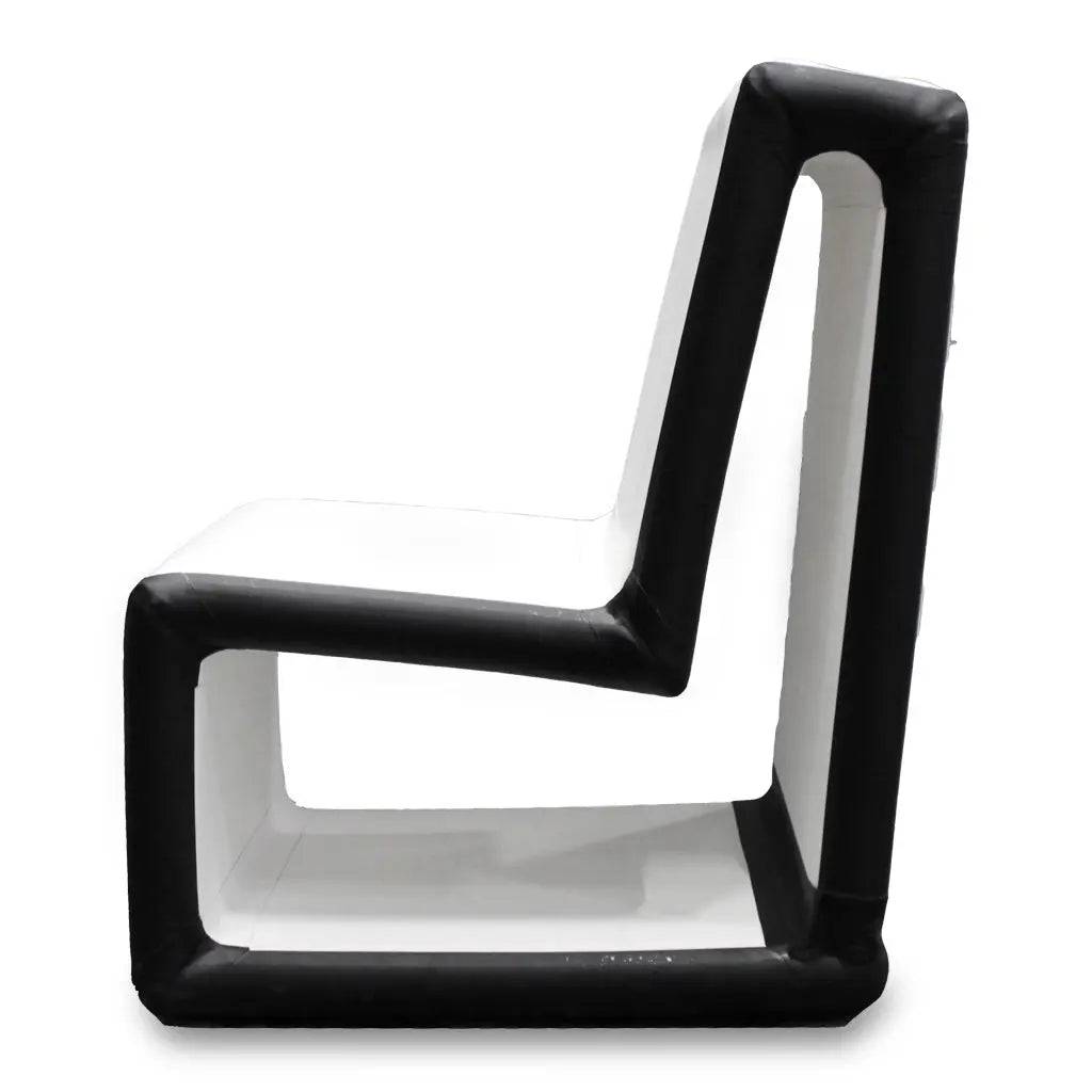 Side view of the FLATED MID-SIZE CHAIR24 (OPEN BOX), a modern, portable chair with a white geometric zigzag design and thick black padding that outlines its angular, contemporary shape.