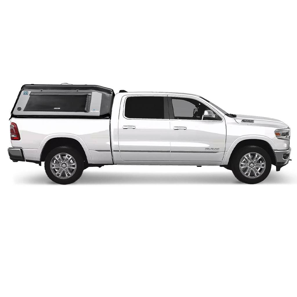 A gray pickup truck with a FLATED FULL-STANDARD DT MR64 black and gray inflatable truck shell attached, featuring a large side window and the FLATED logo.