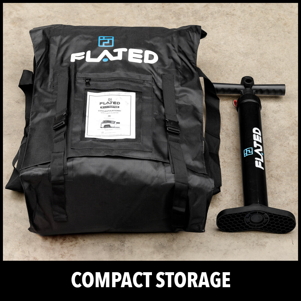 A black FLATED storage bag with handles and a FLATED hand pump placed beside it, both on a concrete floor. The text COMPACT STORAGE is at the bottom of the image.