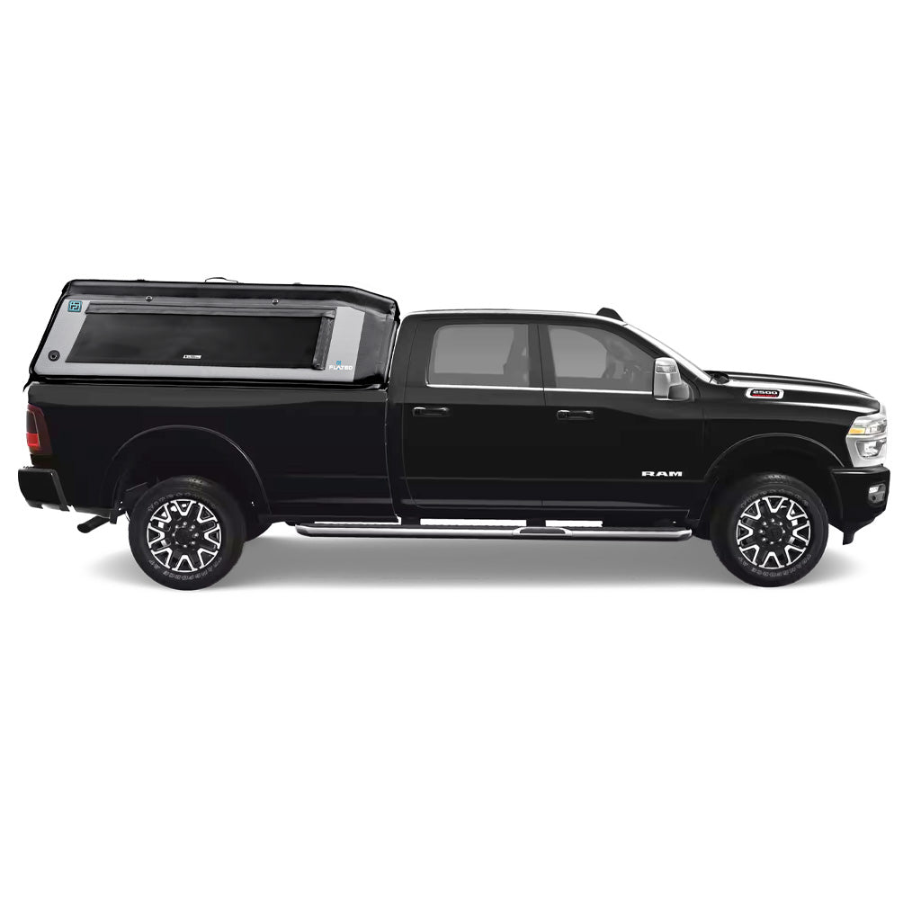 A black pickup truck with a FLATED FULL-LONG MR80 black and gray topper attached to the full-size bed, featuring a side window and a 4x4 logo on the rear side. (Mopar Affiliate)