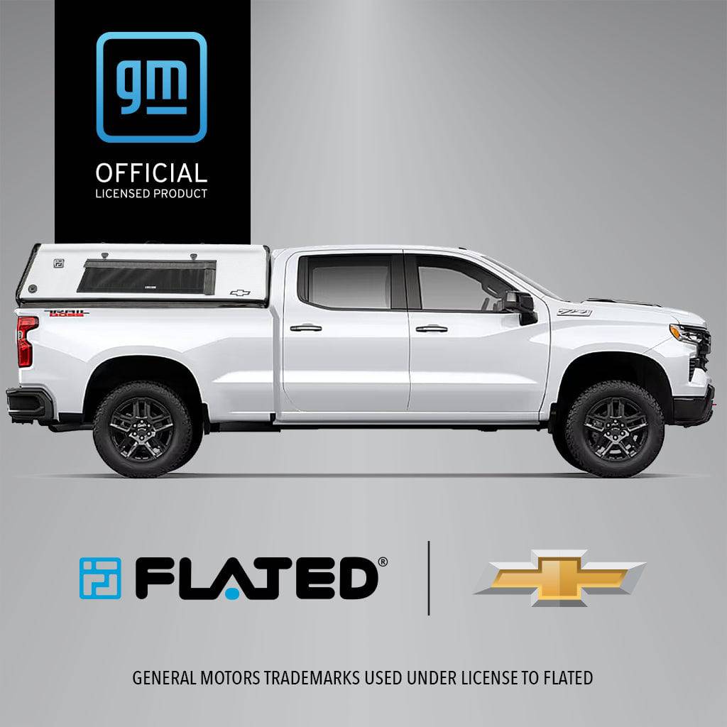 A white Chevrolet pickup truck features the FLATED FULL-STANDARD CAP66 SILVERADO, a black and white GM officially licensed topper. The GM Official Licensed Product logo is visible in the lower right corner of the image.