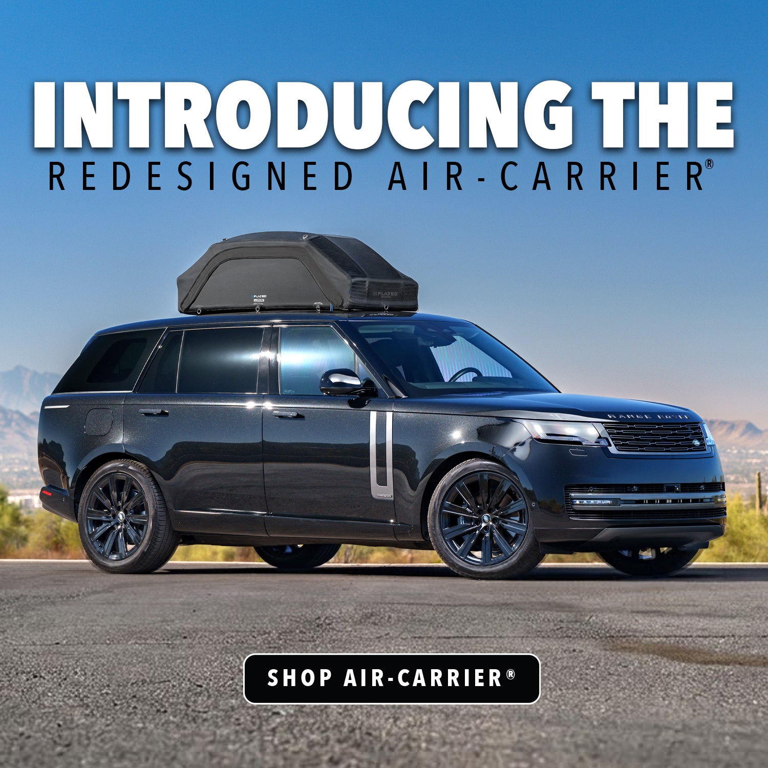 Black Range Rover parked on a road with a roof-mounted cargo carrier, featuring text that reads Introducing the redesigned Air-Carrier and a button that says Shop Air-Carrier.