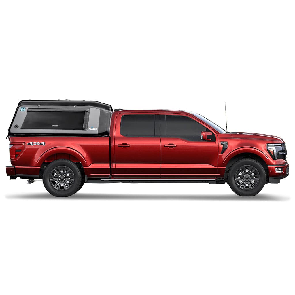 A white full-size pickup with a FLATED FULL-STANDARD MR66 black and gray truck topper, featuring a large side window, branding logos, and a 4x4 label on the side.