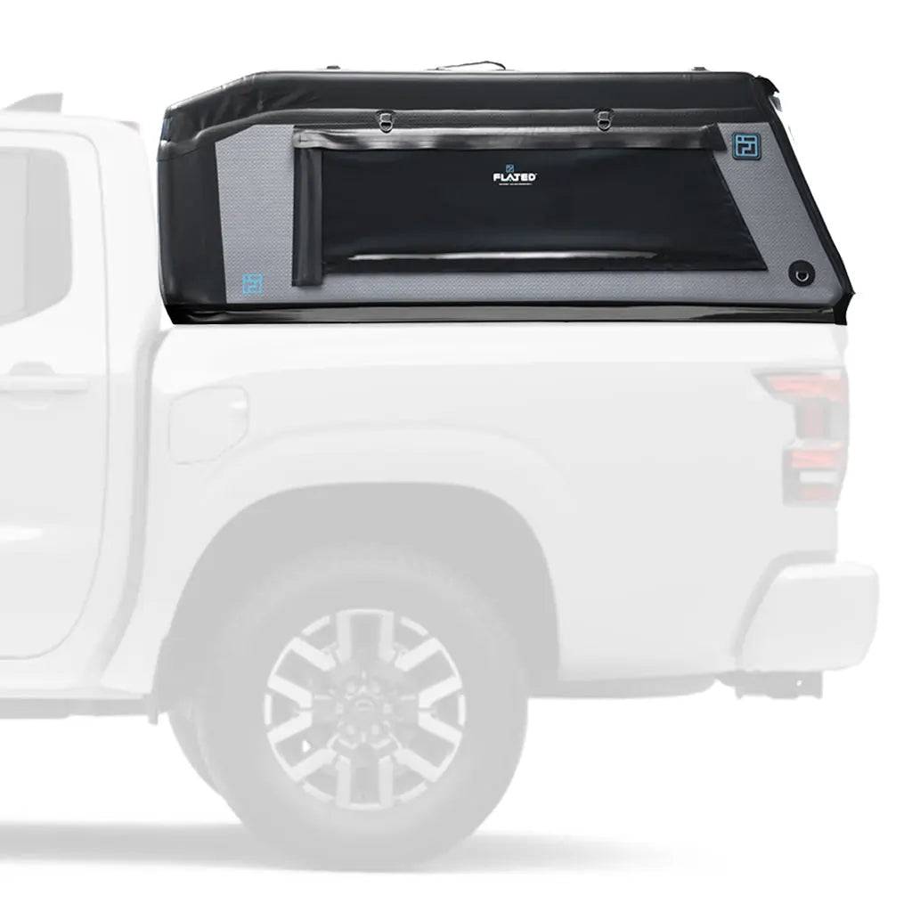 A FLATED MID-SHORT MR411 (OPEN BOX) black truck bed storage box is mounted behind the cab of a white pickup, extending above the bed rails for secure storage under a topper.