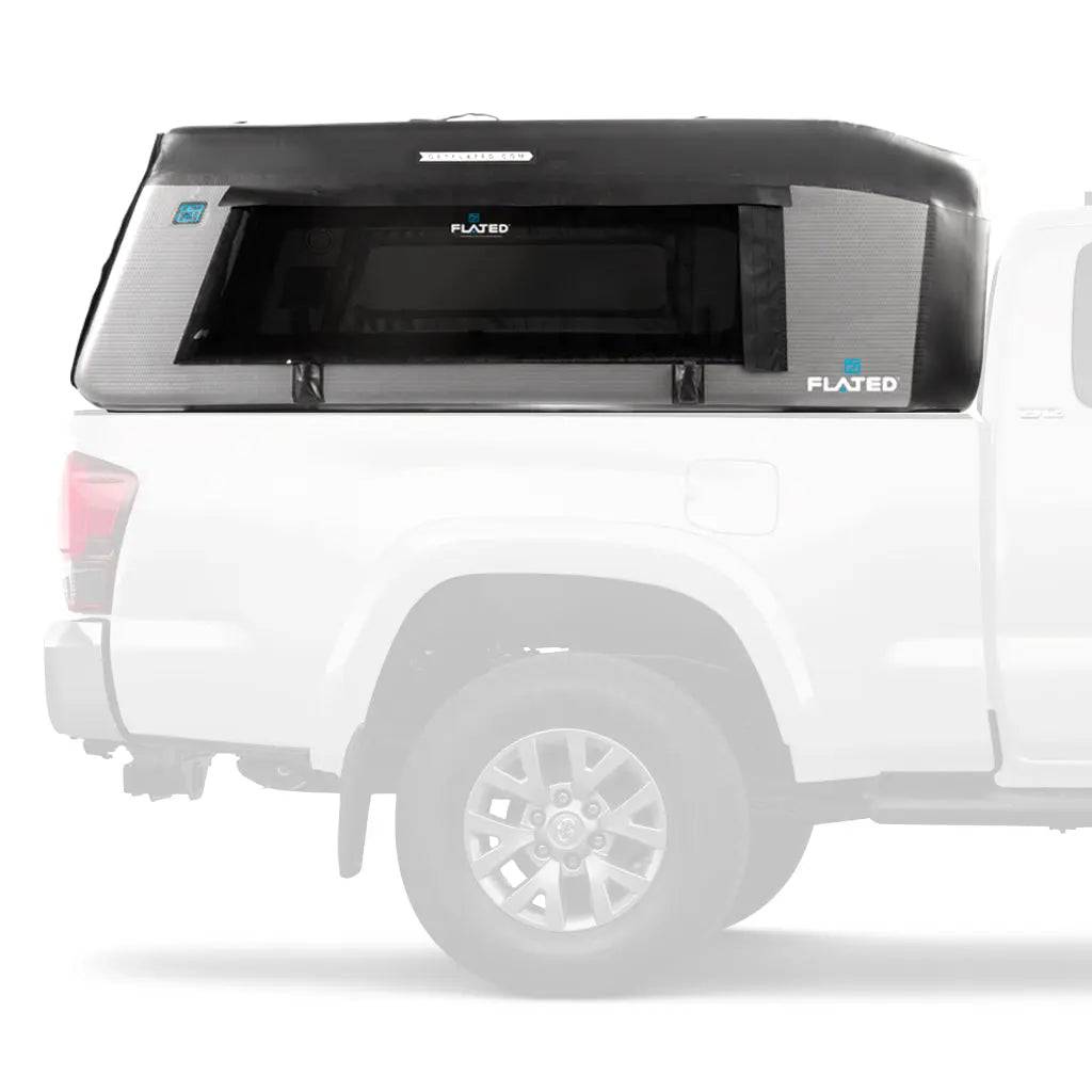 A white pickup truck with a black and gray FLATED MID-LONG MR60 (OPEN BOX) Air-Topper inflatable truck bed topper installed, shown in profile on a plain white background.