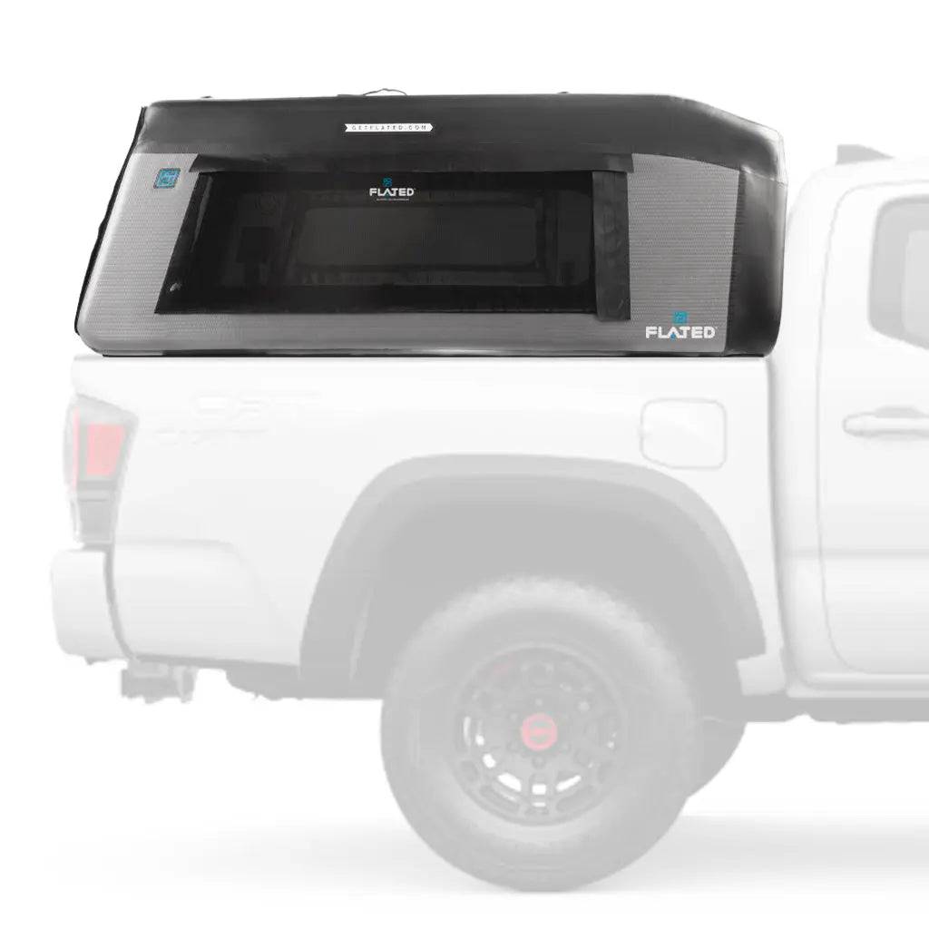 The FLATED MID-SHORT MR50 (OPEN BOX) in black and gray is an inflatable truck shell, perfectly mounted on a white pickup bed and ideal as a mid-size short bed truck topper solution.