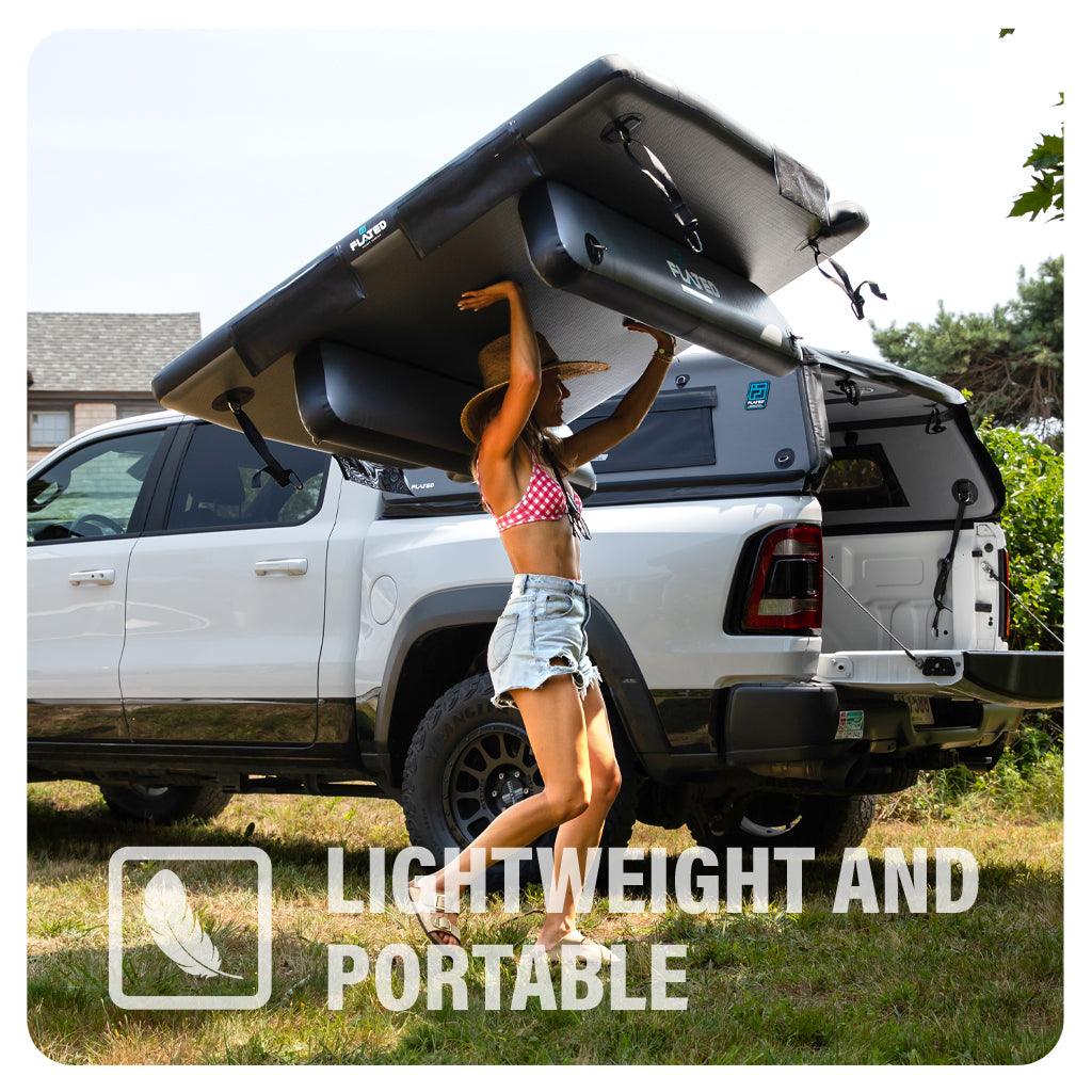 A woman in a red bikini top and denim shorts carries a large inflatable paddleboard over her head next to a white pickup truck in a grassy outdoor area. Text reads: Lightweight and Portable with a feather icon.